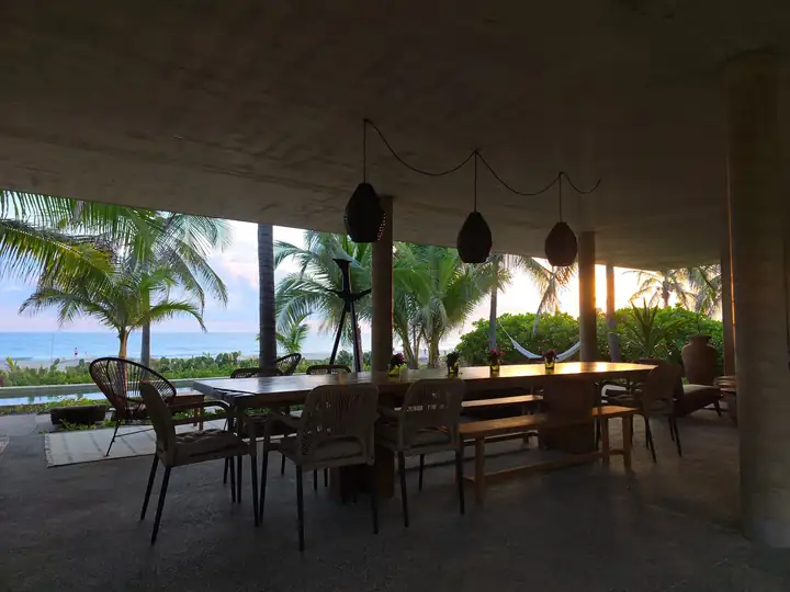 The long dining table under the open vault at Casa Uundu, facing the ocean